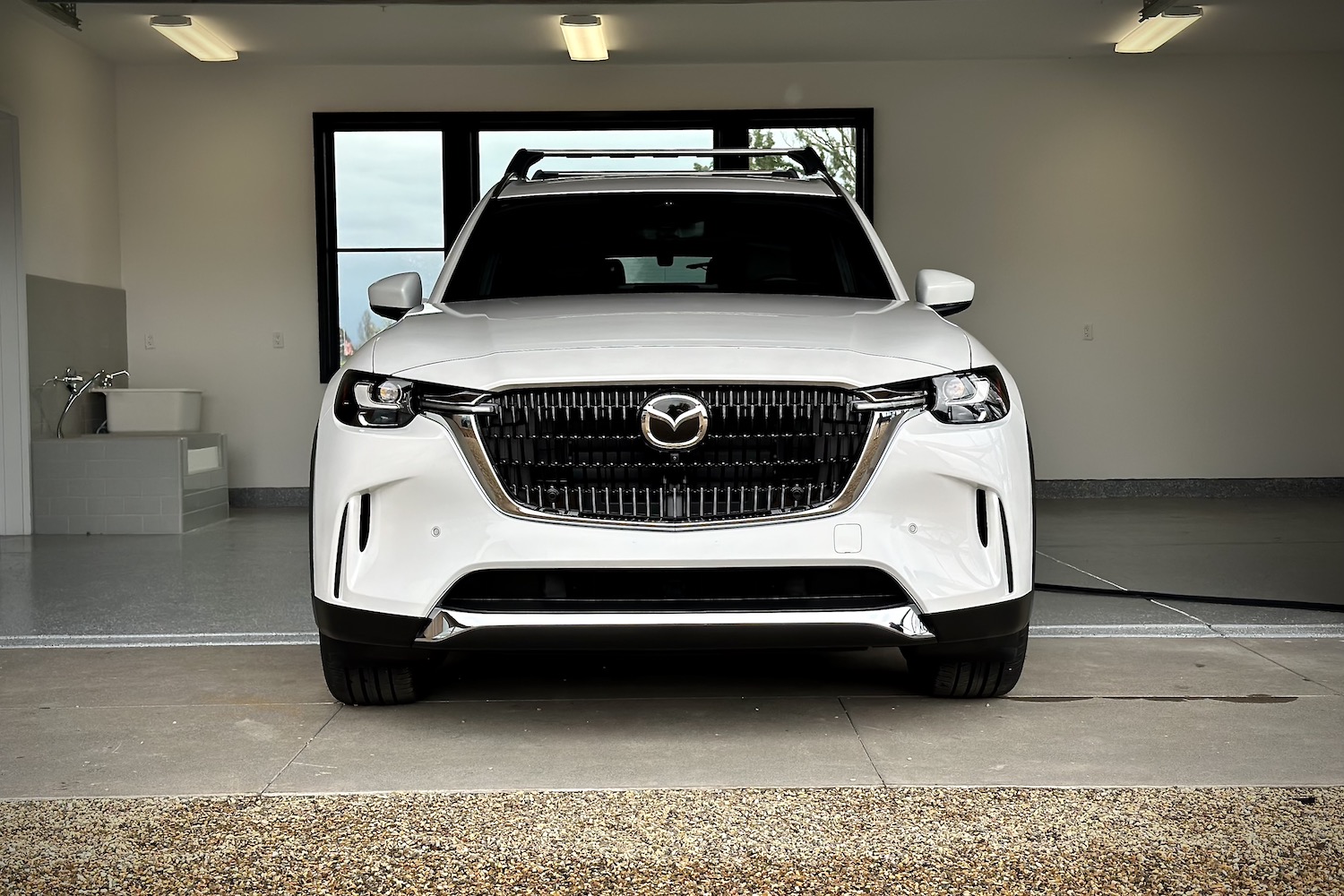 Front end close up of the 2024 Mazda CX-90 PHEV parked in a garage.