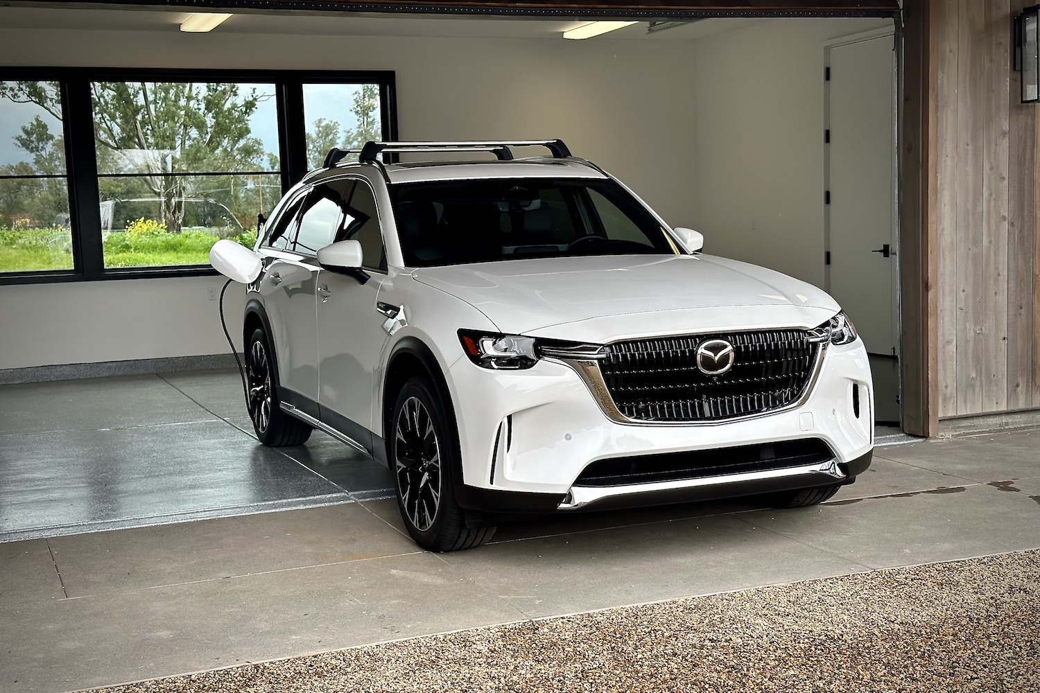 2024 Mazda CX-90 PHEV front end angle from passenger's side parked in a garage.
