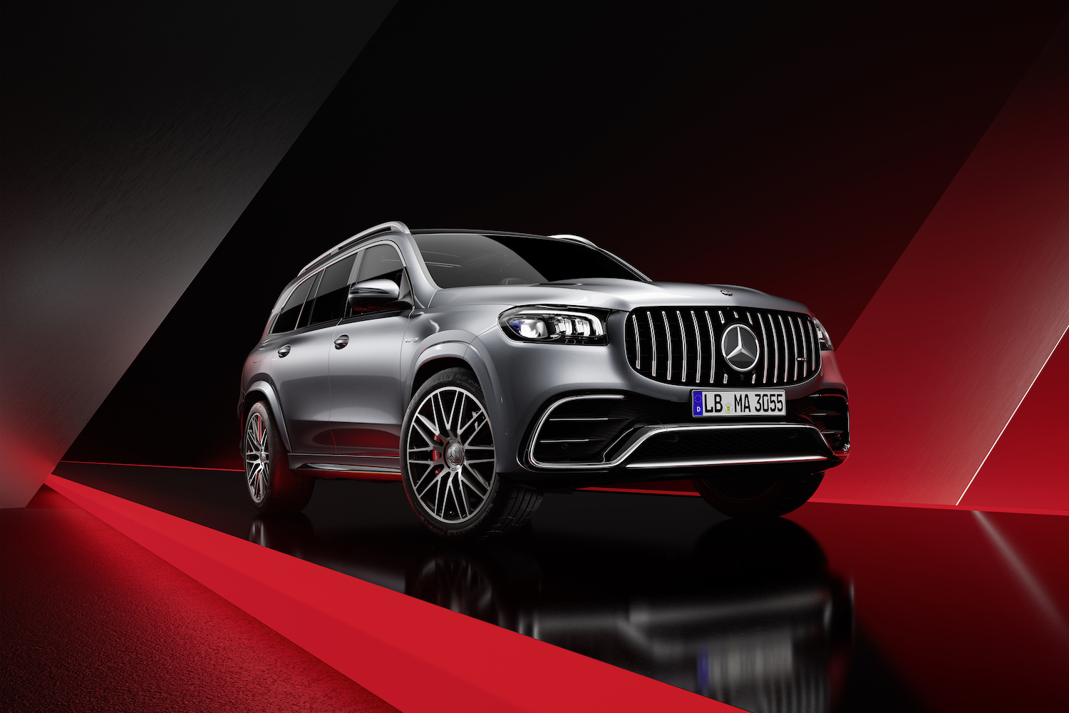 Front end angle of the 2024 Mercedes-Benz GLS AMG 63 with a red and black background.
