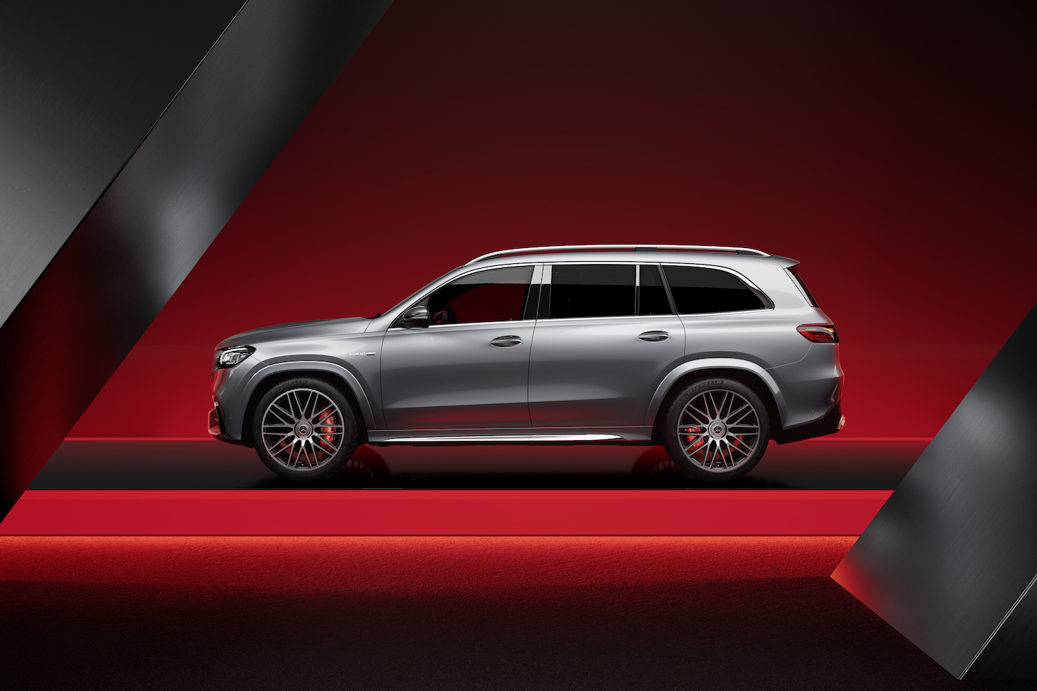 Side profile of the 2024 Mercedes-Benz GLS AMG 63 parked in a red studio.