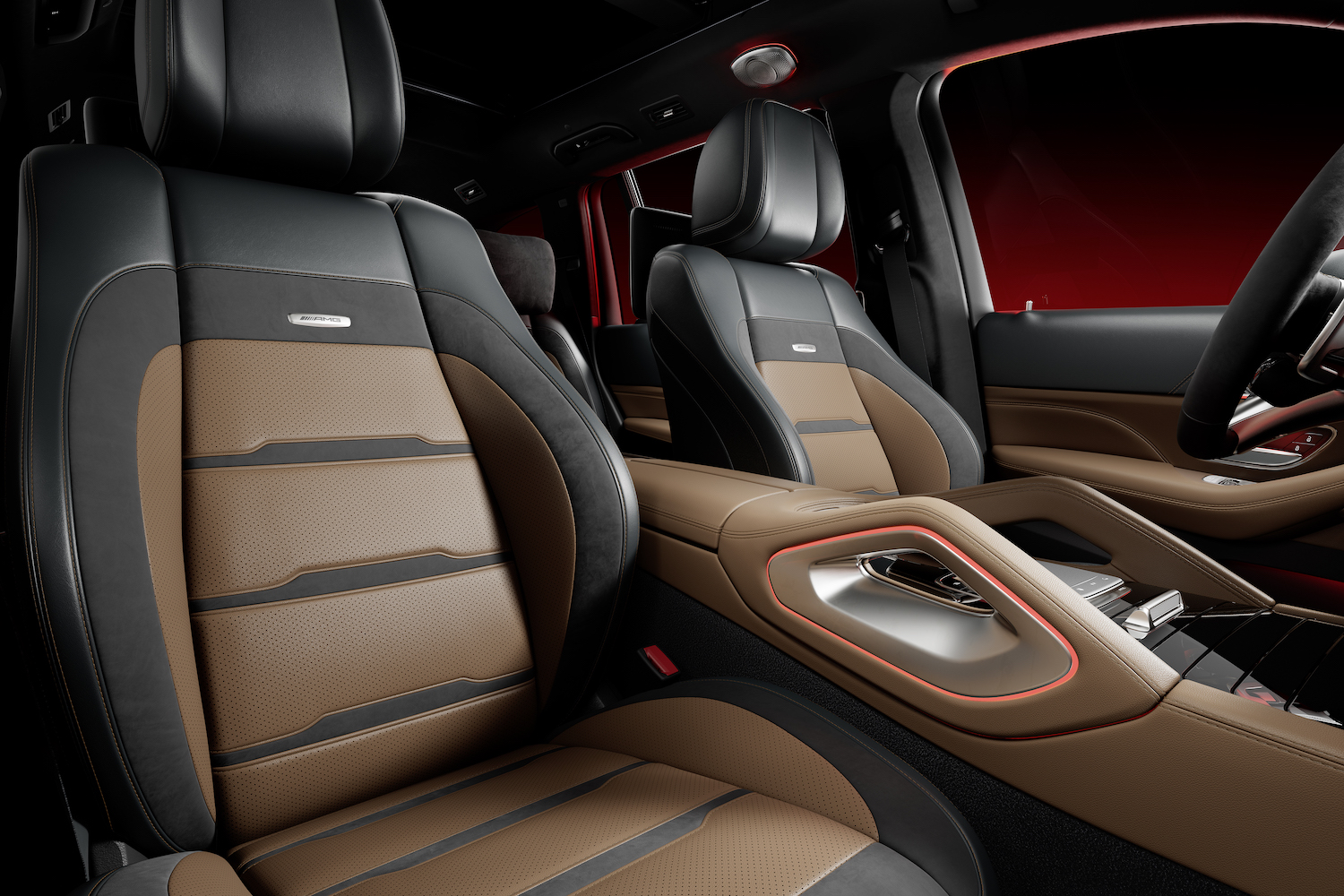 Front seats in the 2024 Mercedes-Benz GLS AMG 63 from passenger side with red background.