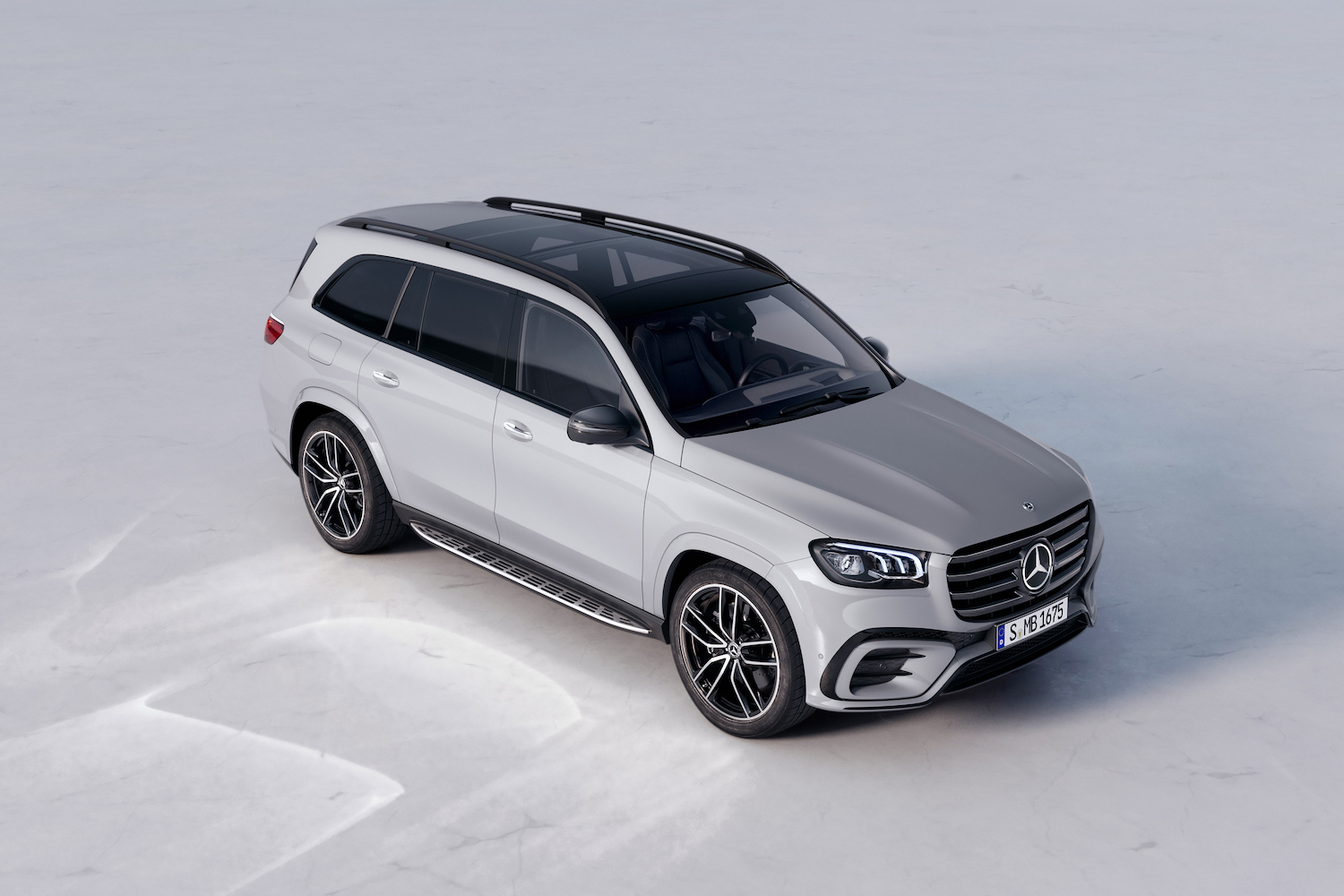 2024 Mercedes-Benz GLS front end angle from overhead with SUV parked in a white studio.