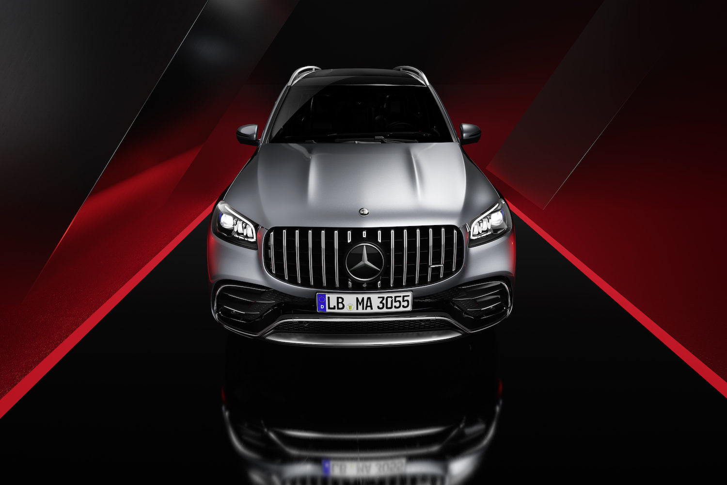 Close up of front end of the 2024 Mercedes-Benz GLS AMG 63 with a black and red background.