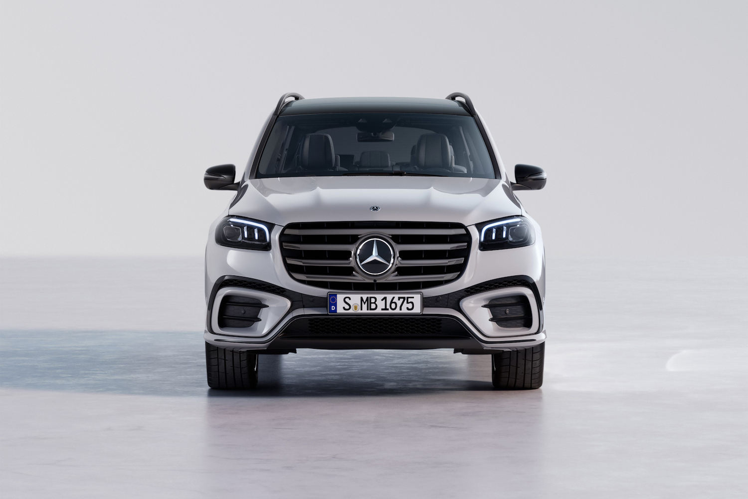 Close up of front end angle of the 2024 Mercedes-Benz GLS parked in a white studio.