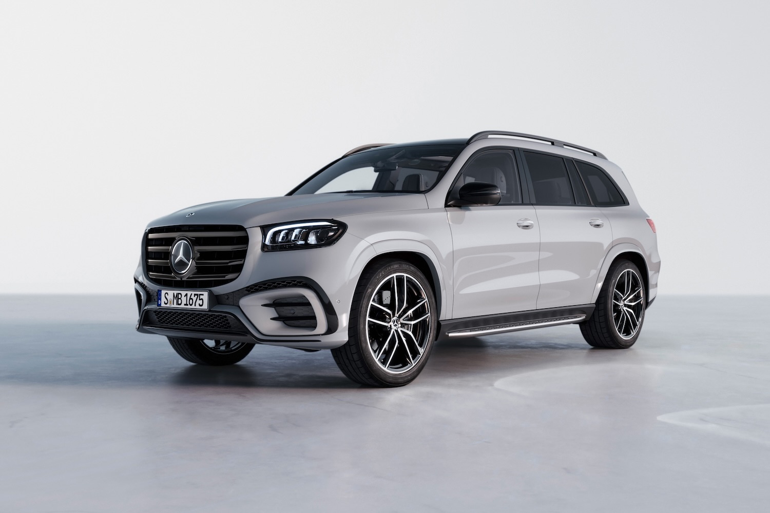 Front end angle of the 2024 Mercedes-Benz GLS from driver's side parked in a white studio.