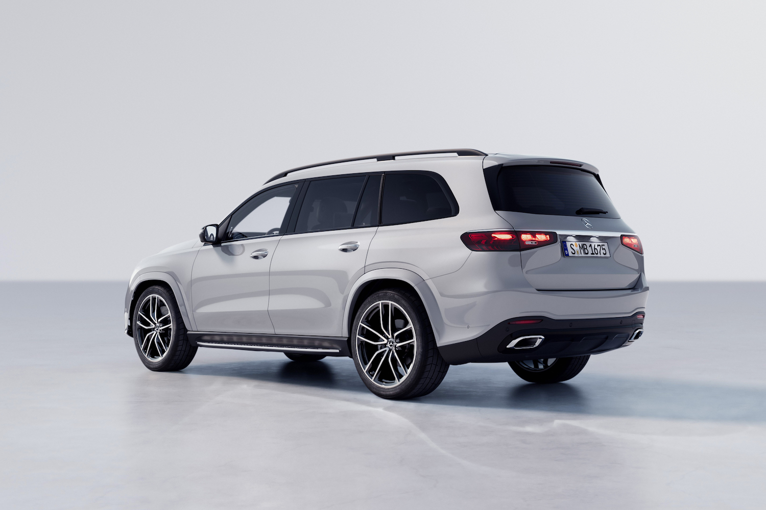 Rear end angle of the 2024 Mercedes-Benz GLS from driver's side parked in a white studio.