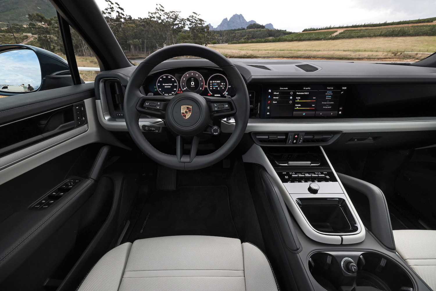 Dashboard and steering wheel in the 2024 Porsche Cayenne from driver's seat.