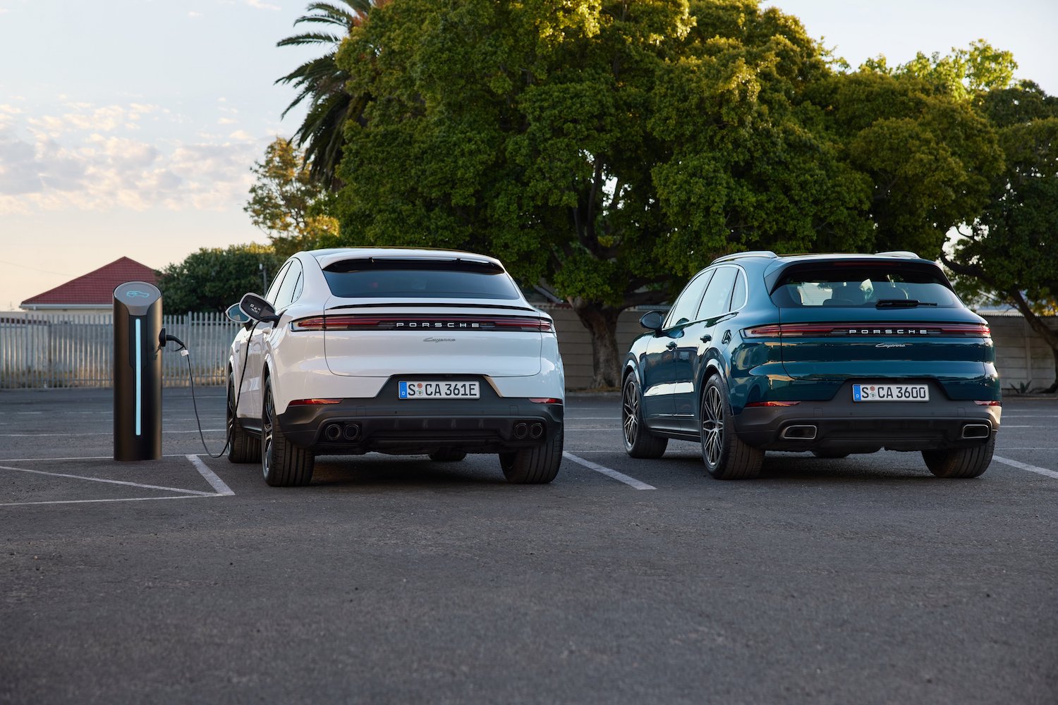 Rear end angle of the 2024 Porsche Cayenne and Cayenne E-Hybrid parked in a parking lot.