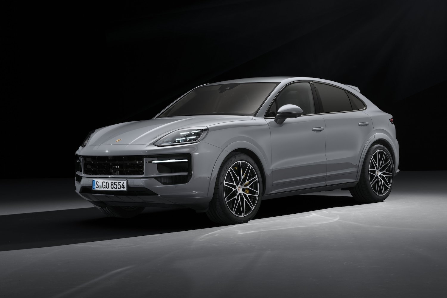 Front end angle of the 2024 Porsche Cayenne S from the driver's side parked in a studio.