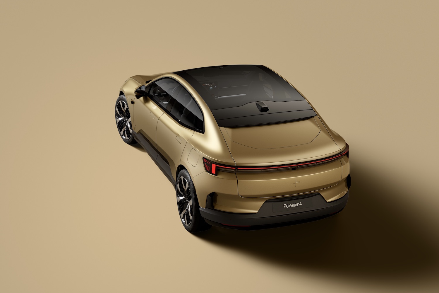 Rear end angle of the 2025 Polestar 4 from overhead in front of a gold background.