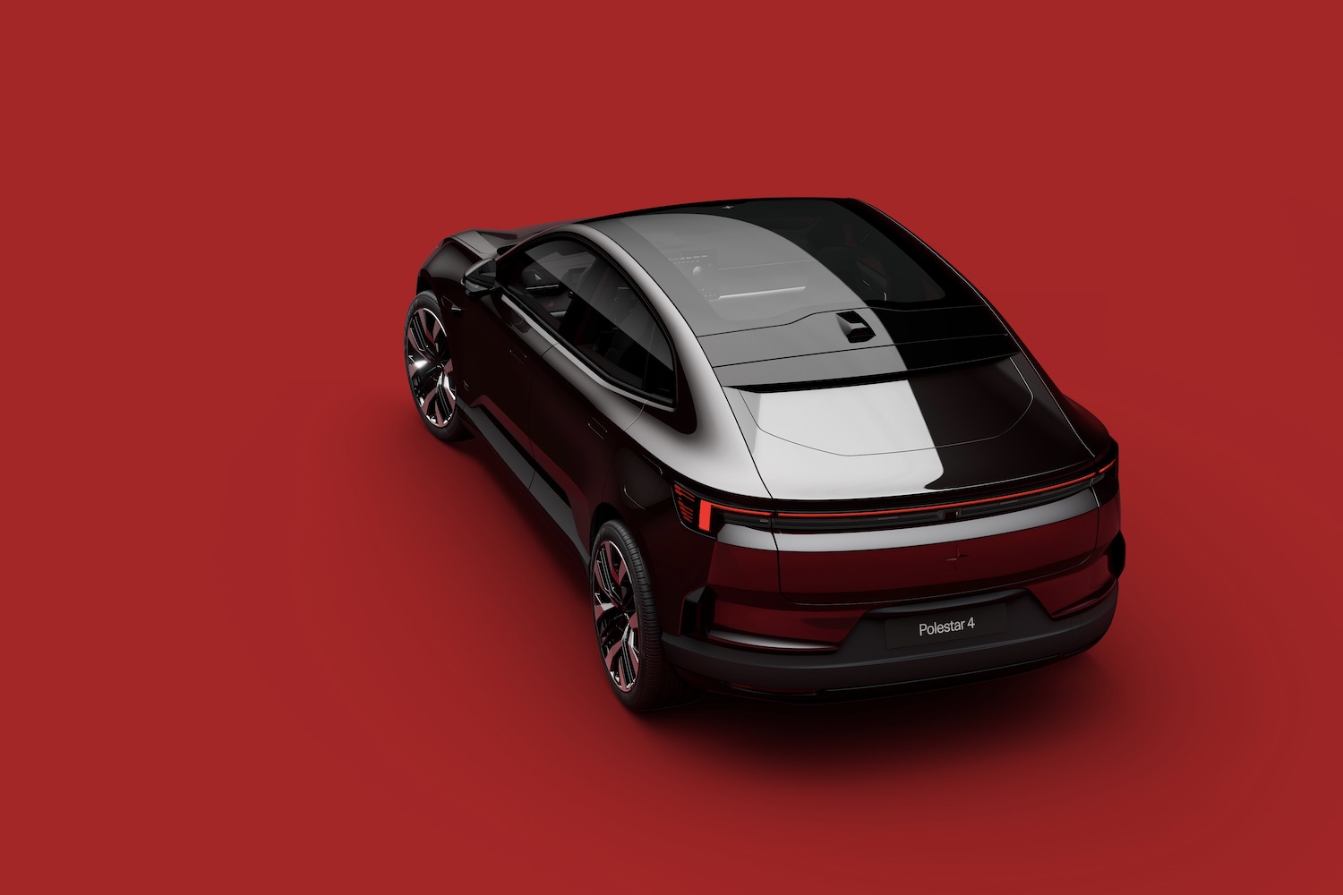 Rear end angle of the 2025 Polestar 4 from overhead in front of a red background.