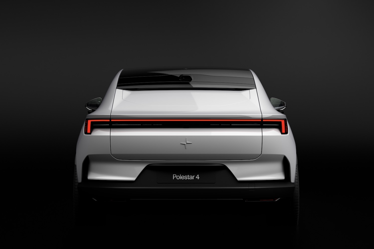 Close up of rear end of the 2025 Polestar 4 parked in front of a black background.