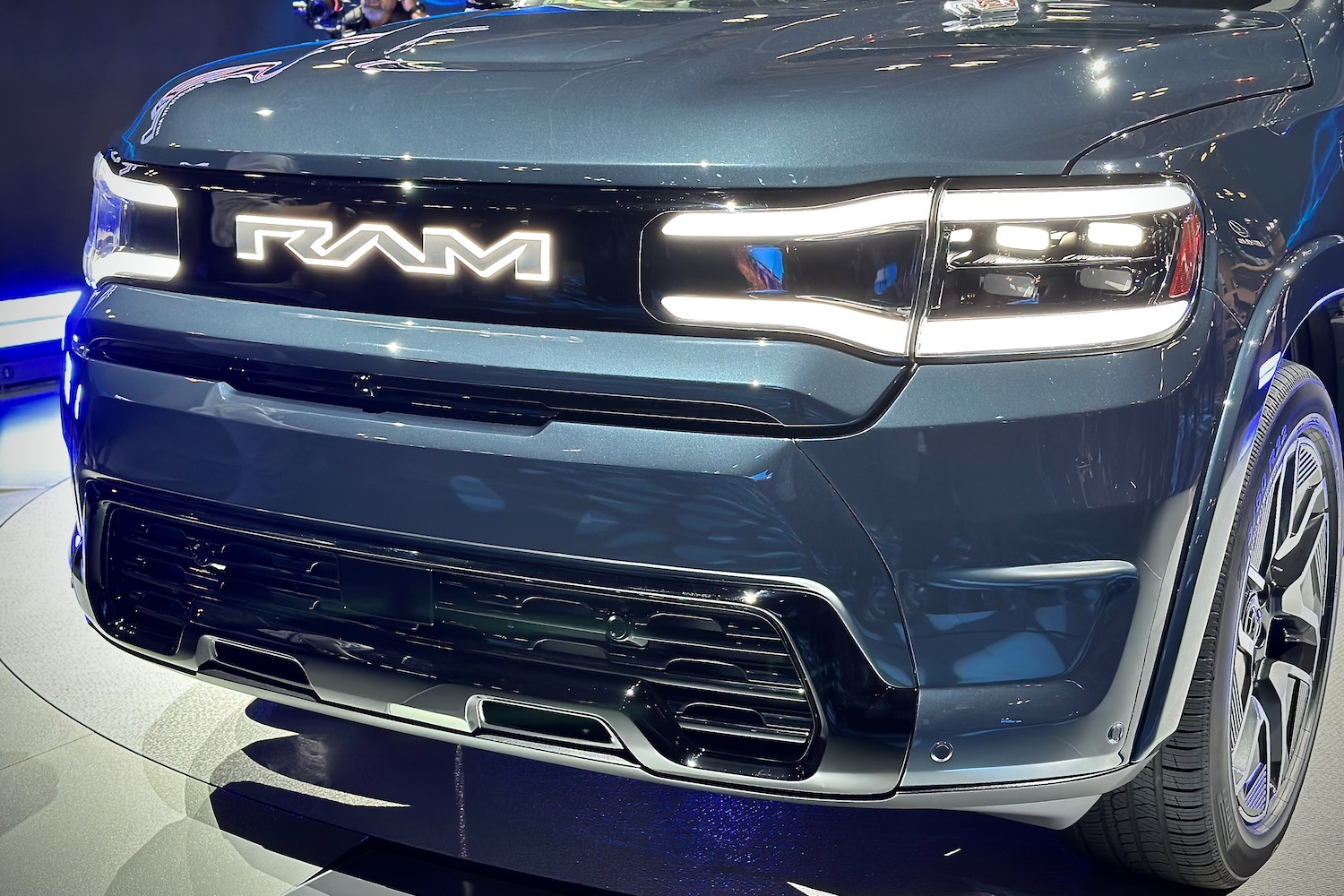 Close up of front end of the 2025 Ram 1500 REV parked on a stage.