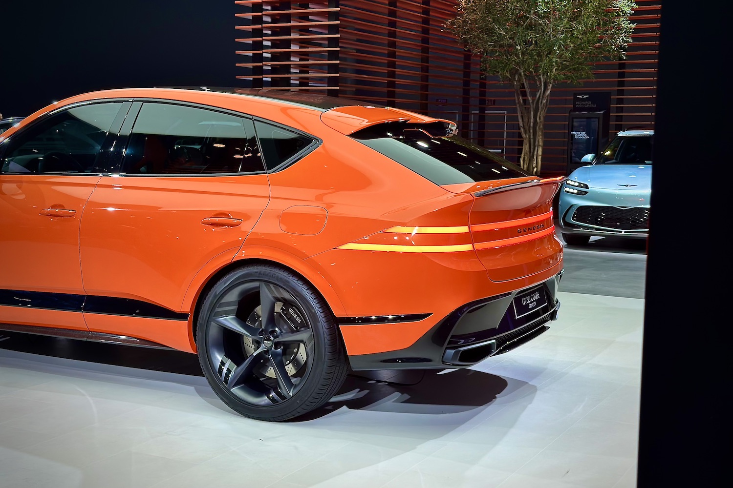 Rear end angle of the Genesis GV80 Coupe from the driver's side parked on as stage.