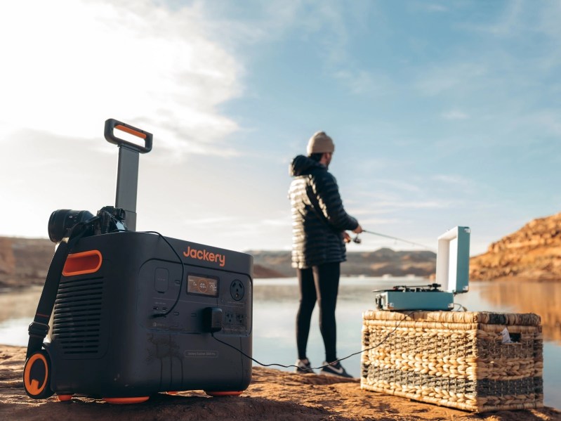 Jackery-Solar-Generator-Pro-used-outdoors-camping with man fishing nearby.