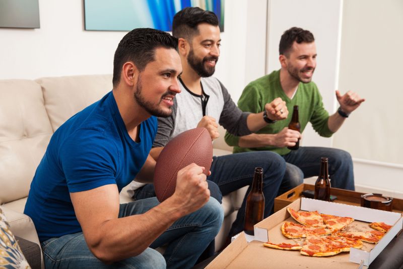 Men watching football in living room