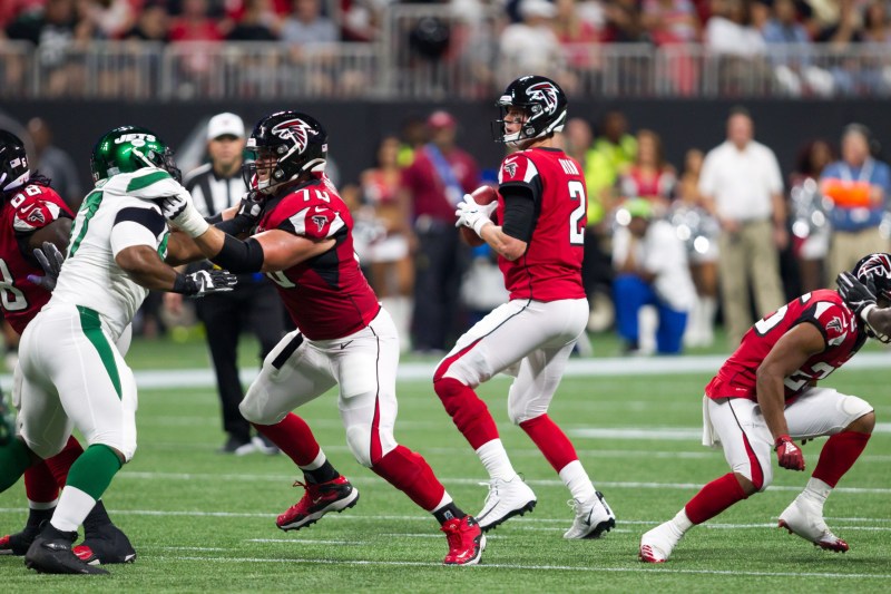 Quarterback throwing football in an NFL game