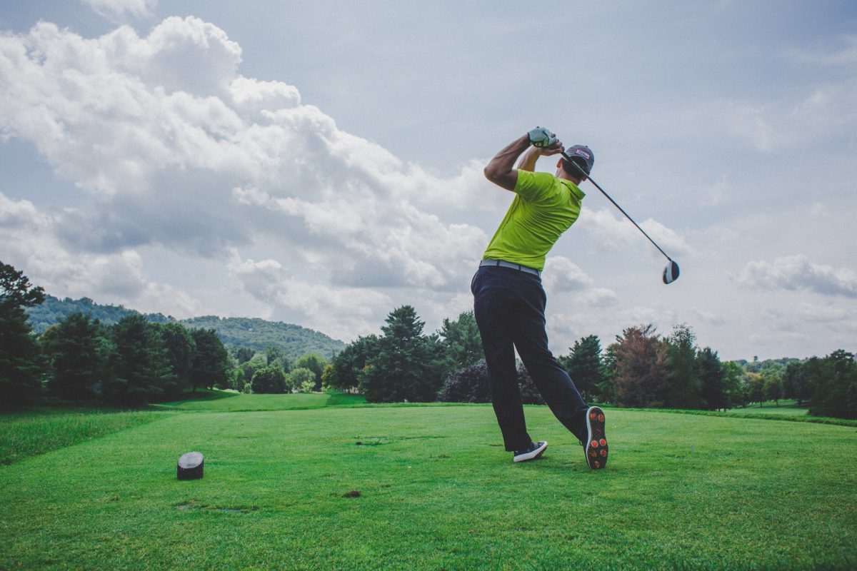 A person hitting a shot on the golf course