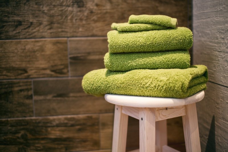 Green towels on a stool