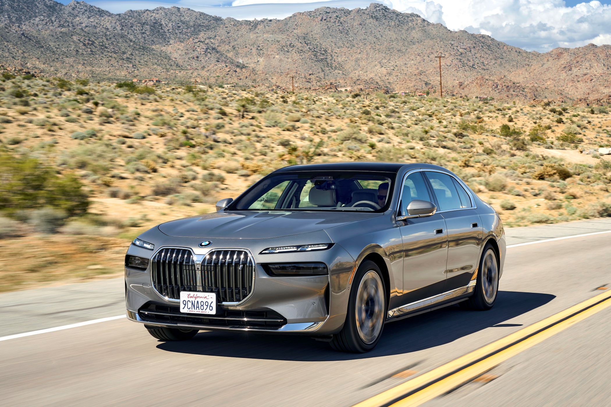 2023 BMW i7 driving on the road.