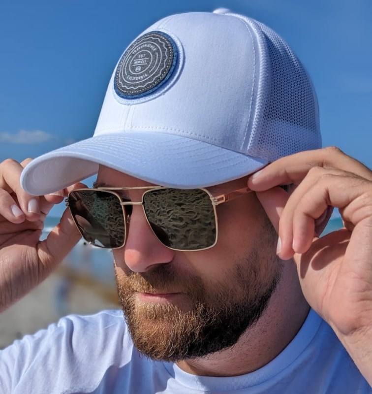 Man in Travis Mathew hat and Privé Revaux sunglasses