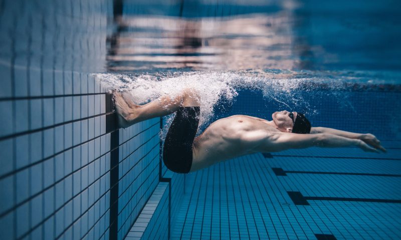Man swimming in a pool.
