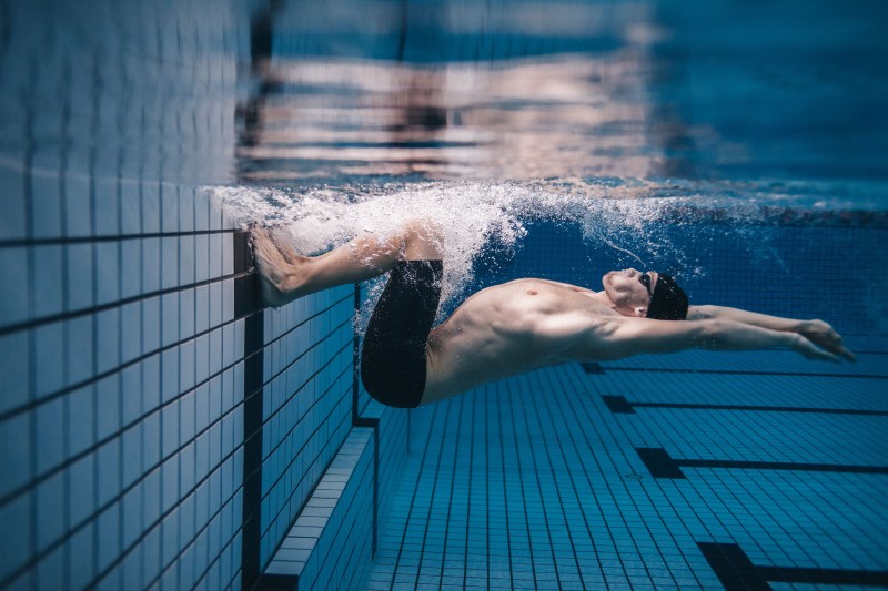 Man swimming in a pool.