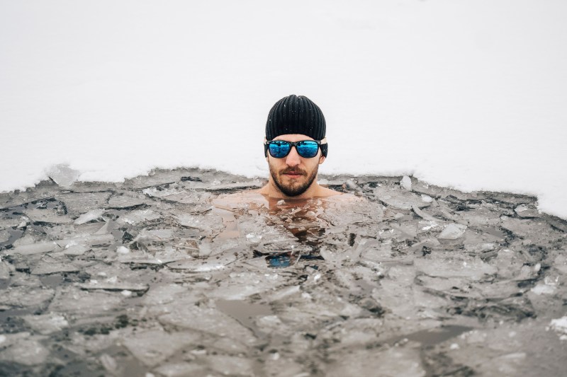 man swimming in ice