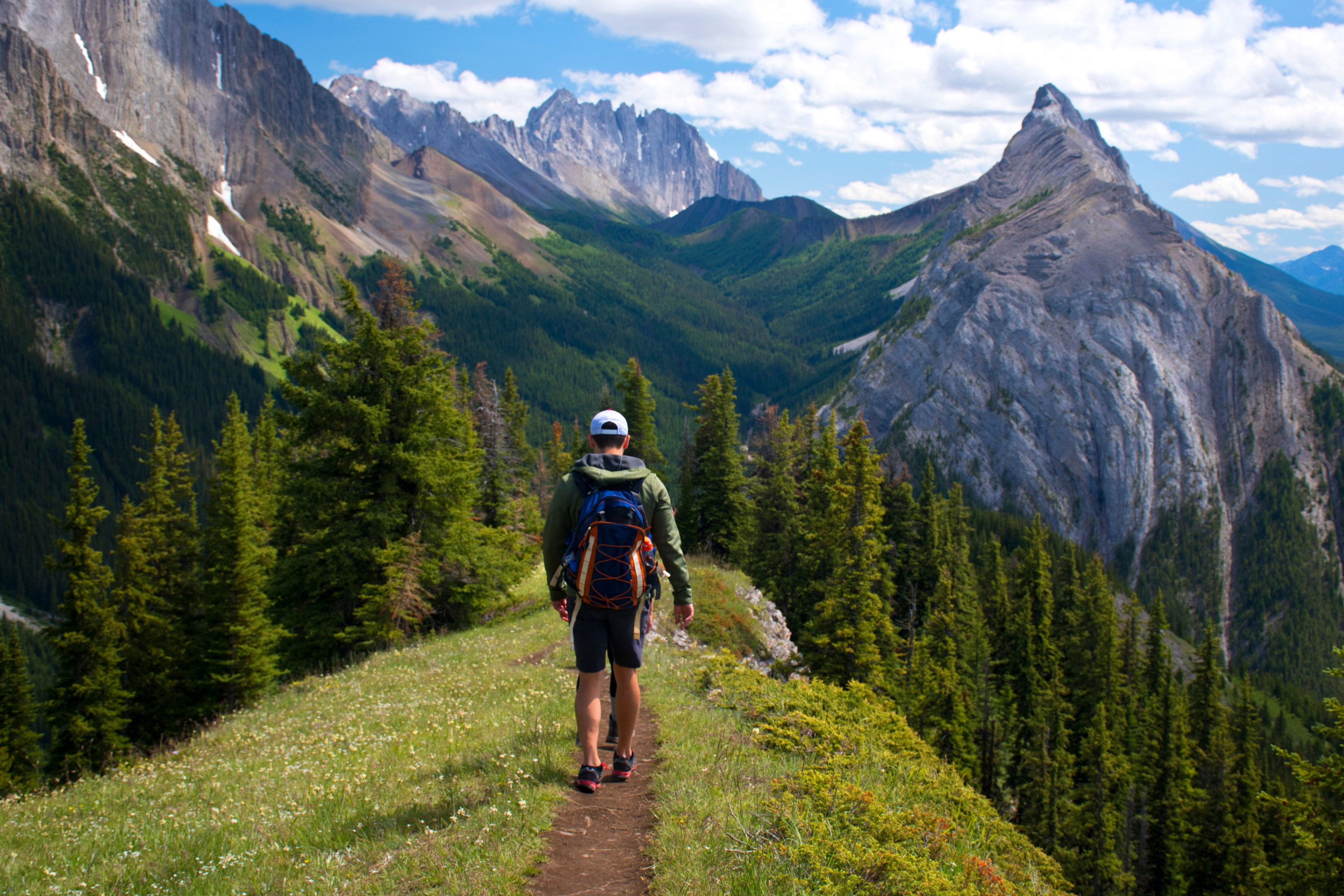 Young man hiking through the mountains.