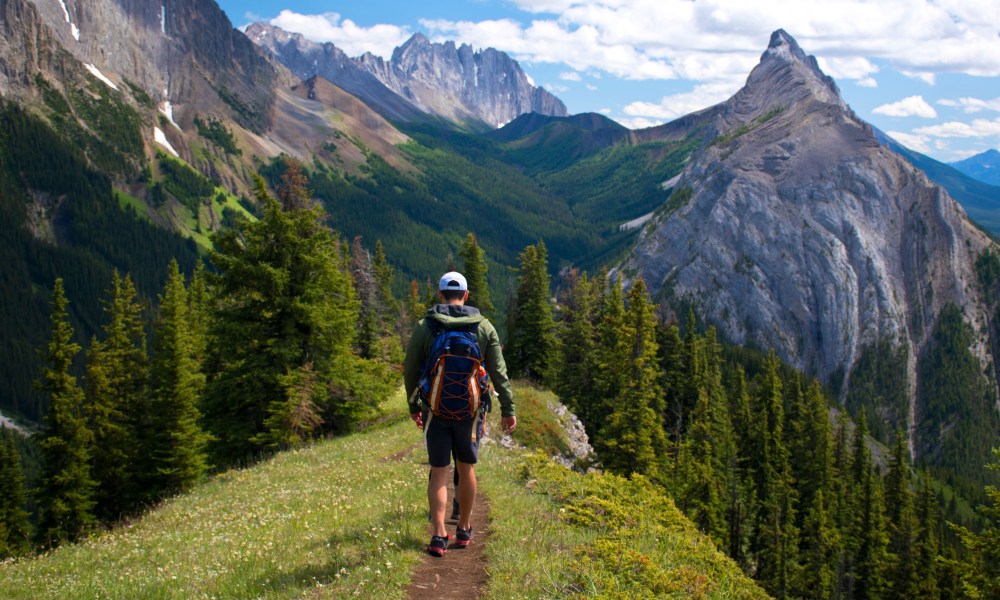 Young man hiking through the mountains