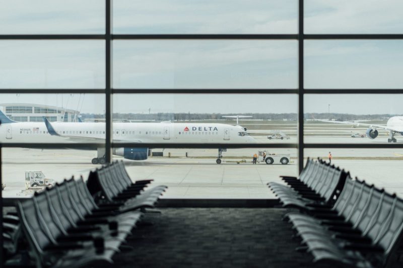 A view of a Delta airplane out of an airport window.