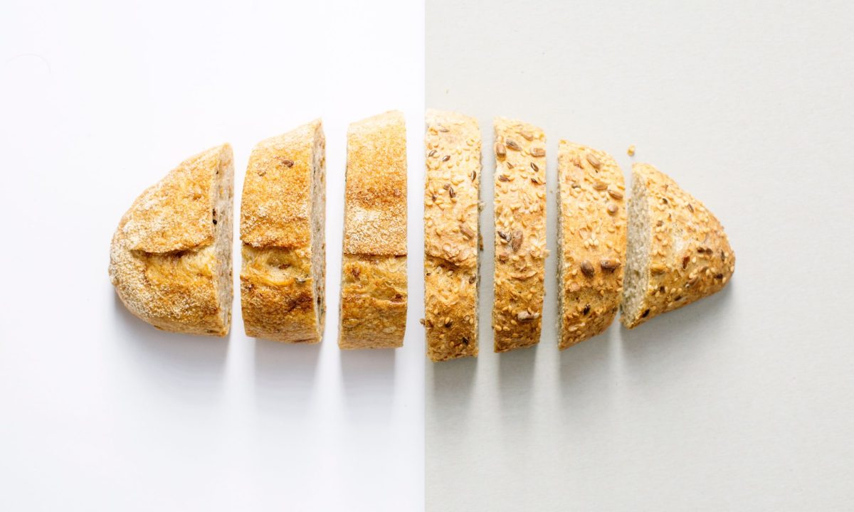 Baked bread sliced on a white table