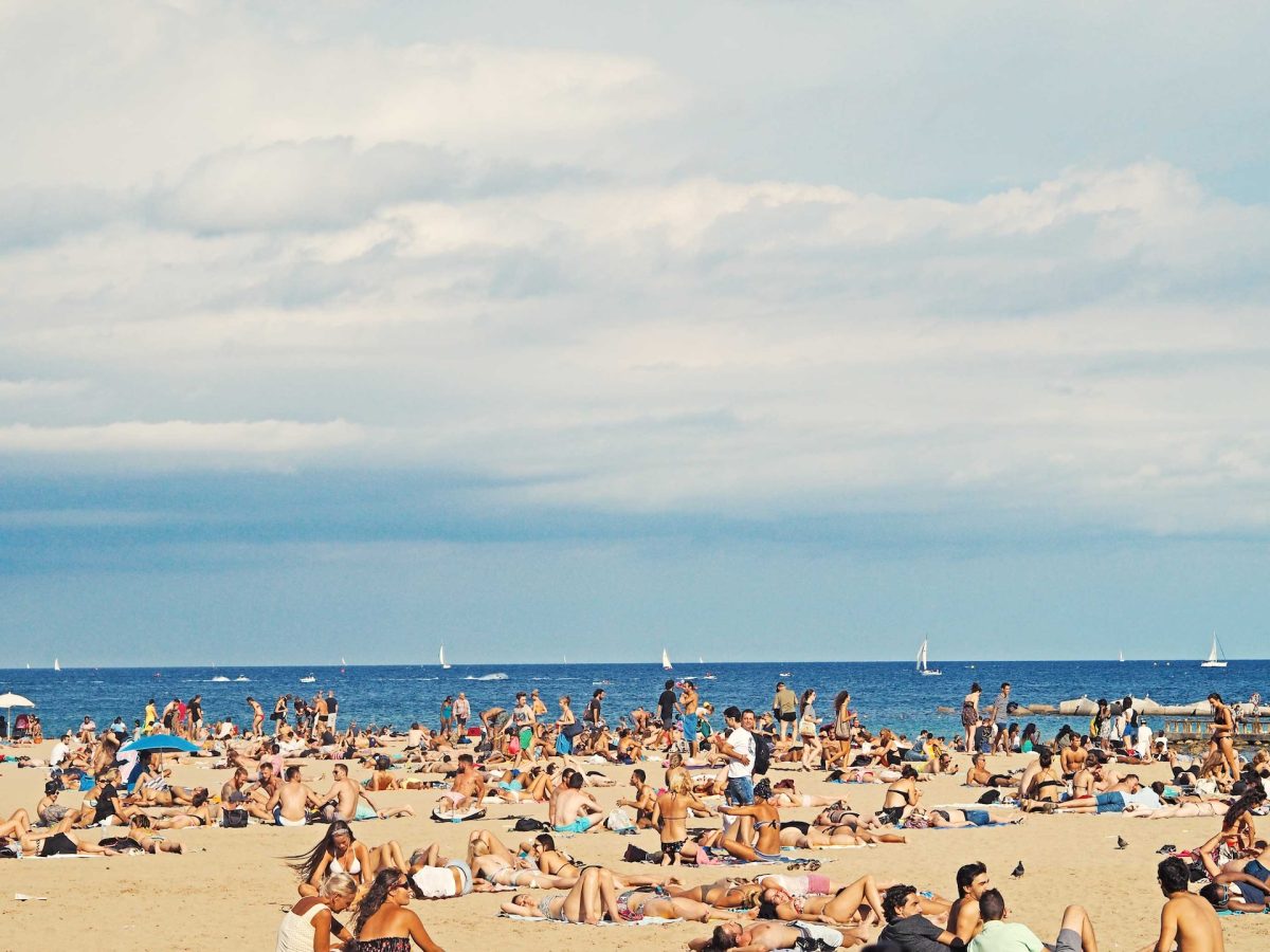A crowded beach in the summer.
