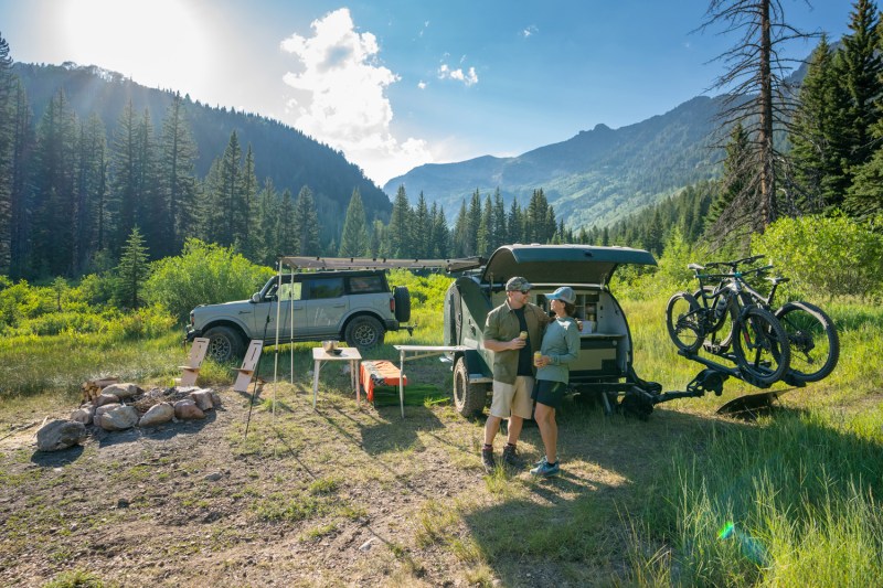 Couple camping with the new 2023 Escapod TOPO2 Teardrop Trailer.