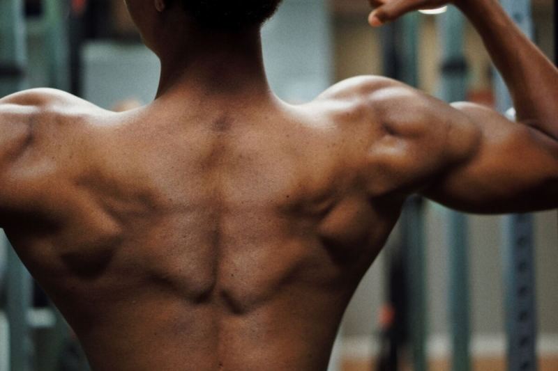 Man flexing his back and shoulders.