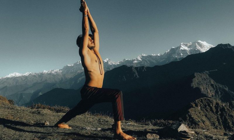 Man doing yoga outdoors