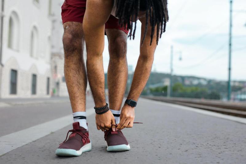 Man tying his shoes.