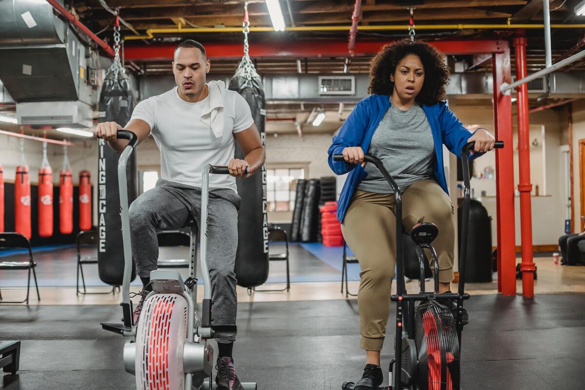 Man and woman on stationary bikes.