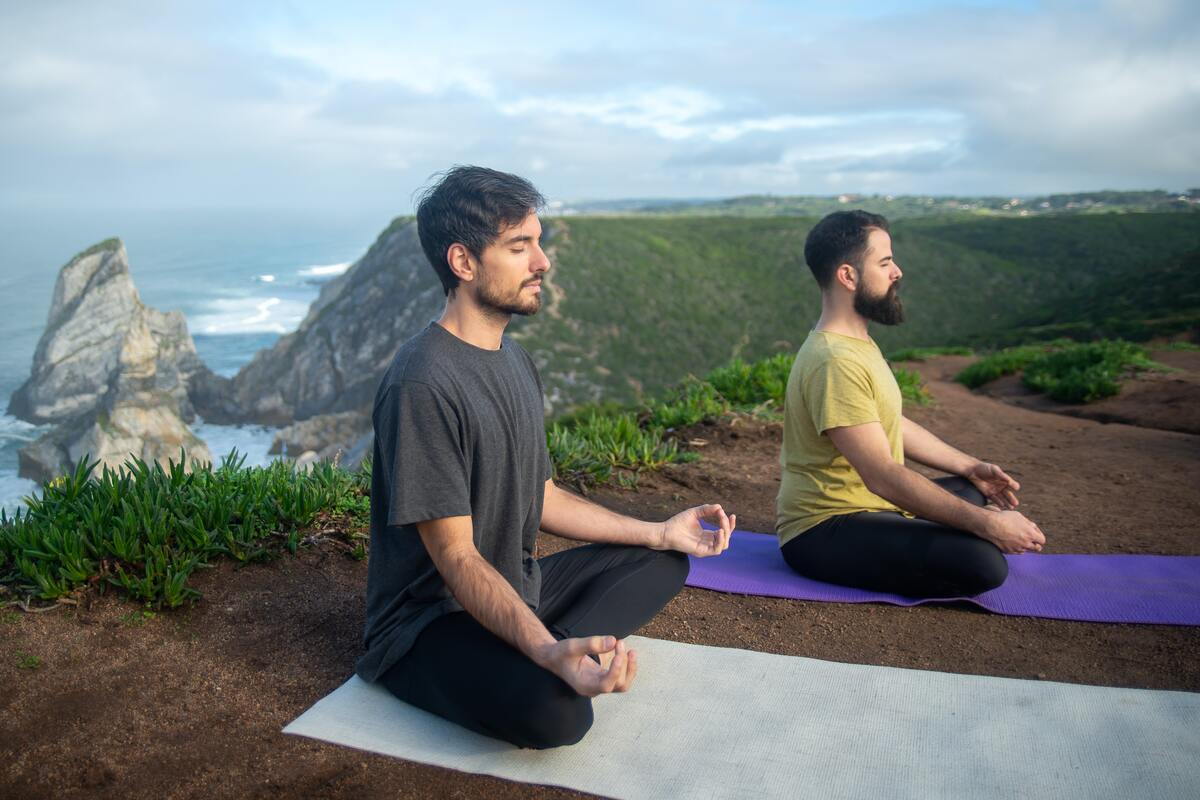 Two men meditating outdoors.