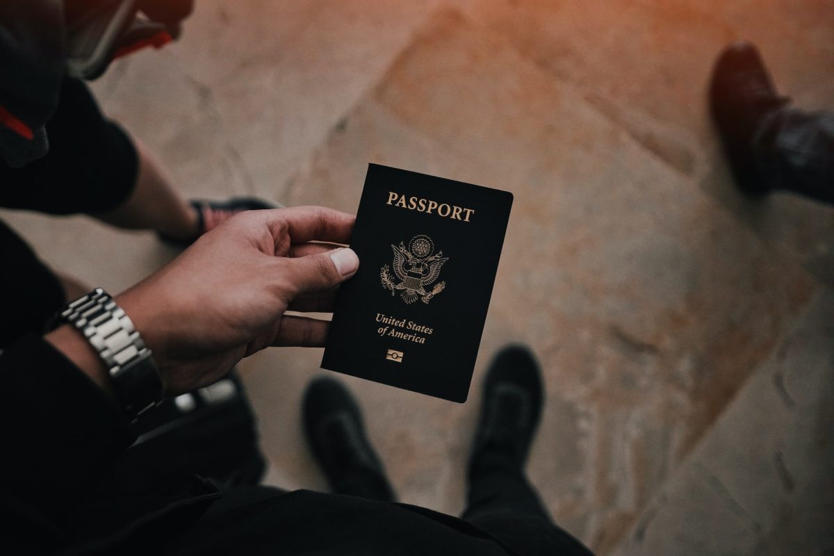 A person holding a passport down.