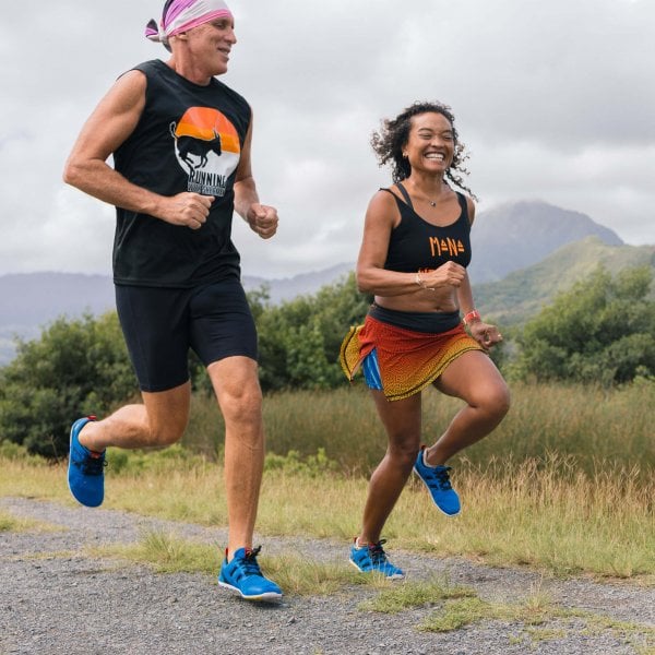 Two people running in barefoot shoes on the trail