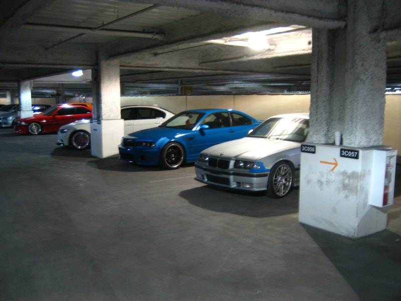 Colorful BMWs in a parking structure