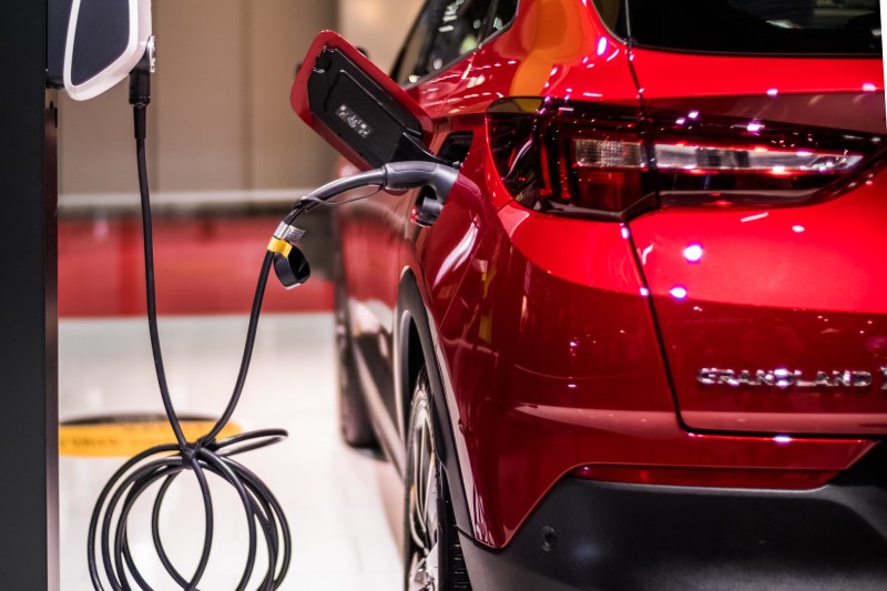 Red electric vehicle plugged in
