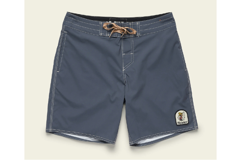 Howler Brothers Buchannon Boardshorts in gray navy on a beige background.
