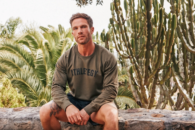 Man in Athletegy sweatshirt and shorts