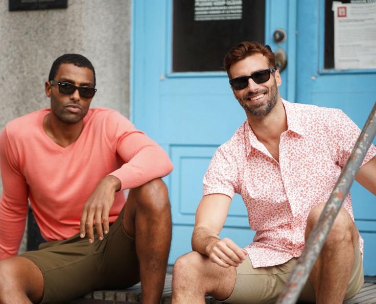 Two men sitting on porch in Highland Duds
