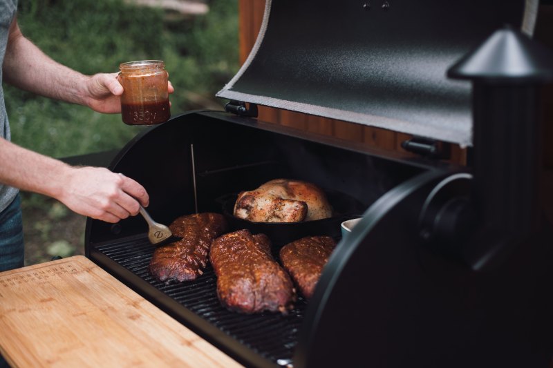 Applying sauce on the grill.
