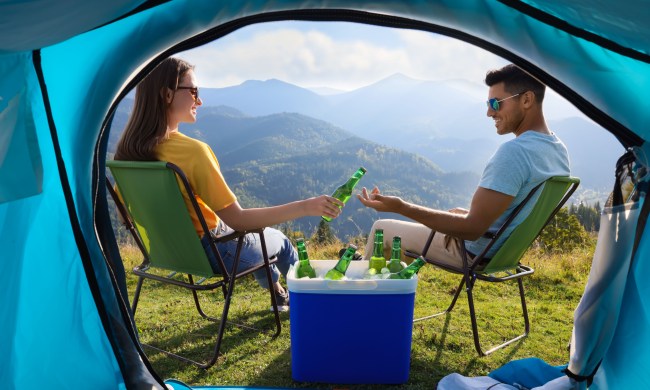 Couple camping with cooler and beer