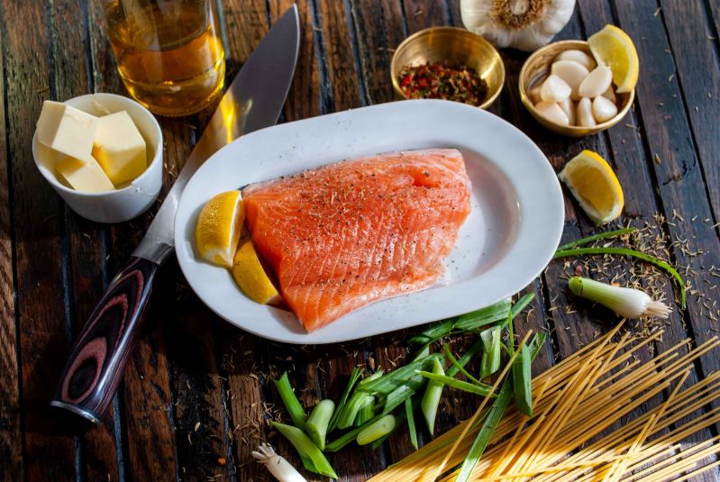 Raw salmon on plate with other ingredients