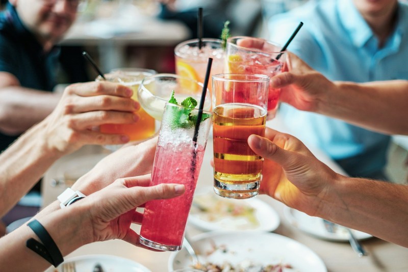 Hands toasting with cocktails